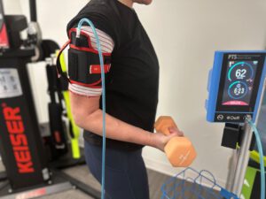 Blood flow restriction on the arm while performing a bicep curl